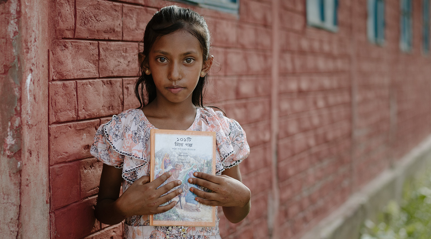 Rumana in Bangladesh holds a children's Bible