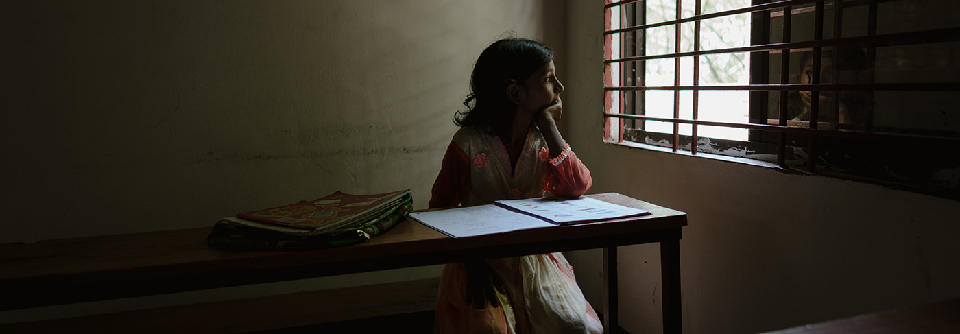 A girl in Bangladesh looking out the window at school